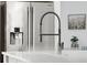 Modern kitchen faucet and stainless steel refrigerator complete with water dispenser on bright countertop at 233 Camber Rd, Huger, SC 29450