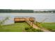 Scenic lake access with a charming wooden dock and walkway, ideal for lakeside enjoyment at 233 Camber Rd, Huger, SC 29450