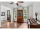 Cozy living room with hardwood floors, large windows and a vintage china cabinet at 233 Camber Rd, Huger, SC 29450