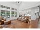 Open concept living room with hardwood floors and comfortable leather furniture throughout home at 233 Camber Rd, Huger, SC 29450