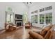 Inviting living room with tall ceilings, fireplace, and ample natural light from many windows at 233 Camber Rd, Huger, SC 29450