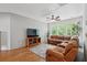 Spacious living room features a plush sectional sofa, hardwood floors, and a wall-mounted television for comfortable living at 233 Camber Rd, Huger, SC 29450