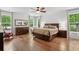 Spacious main bedroom with hardwood floors, a ceiling fan and ample natural light at 233 Camber Rd, Huger, SC 29450