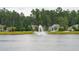 Scenic view of homes across a pond with a fountain at 233 Camber Rd, Huger, SC 29450
