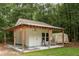 Charming shed with porch offers extra storage or workshop space in the backyard at 233 Camber Rd, Huger, SC 29450