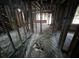 Stripped interior showing wood beams, exposed framing, studs, wood floors, and room layout at 2334 Kent Ave, North Charleston, SC 29405