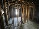 Stripped interior showing wood beams, exposed framing, studs, wood floors, and room layout at 2334 Kent Ave, North Charleston, SC 29405