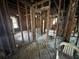 Stripped interior showing wood beams, exposed framing, studs, wood floors, and room layout at 2334 Kent Ave, North Charleston, SC 29405