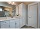 Modern bathroom featuring a white vanity with marble countertop, white cabinets, and a large mirror at 265 Huguenot Trl, Huger, SC 29450