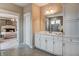 Bright primary bathroom with tile floors, marble vanity with double sinks, and glass enclosed shower at 265 Huguenot Trl, Huger, SC 29450