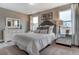 Bright bedroom showcases neutral paint, plush bedding, windows, and decorative lamps at 265 Huguenot Trl, Huger, SC 29450