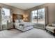 Bright bedroom with large windows, wooden headboard, and neutral decor for a serene atmosphere at 265 Huguenot Trl, Huger, SC 29450