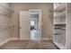 Spacious walk-in closet with custom shelving and an open doorway into a bedroom area at 265 Huguenot Trl, Huger, SC 29450