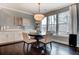 Dining area features a round table, large windows with natural light, and built-in cabinets at 265 Huguenot Trl, Huger, SC 29450