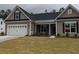 Single story home with taupe siding, covered porch, and a neatly kept green lawn at 265 Huguenot Trl, Huger, SC 29450