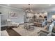 Bright living room featuring an open floor plan with dark wood floors, neutral furnishings, and stylish décor at 265 Huguenot Trl, Huger, SC 29450