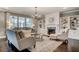 Inviting living room featuring a cozy fireplace, built-in shelving, and comfortable seating arrangements at 265 Huguenot Trl, Huger, SC 29450