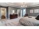 This spacious main bedroom features a tray ceiling, carpeting, windows, and a beautiful ensuite bathroom at 265 Huguenot Trl, Huger, SC 29450