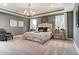 This spacious main bedroom features a tray ceiling, carpeting, windows, and ensuite bathroom at 265 Huguenot Trl, Huger, SC 29450