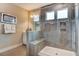 Elegant shower showcasing gray tiles, a glass door, and a built-in bench for a spa-like experience at 265 Huguenot Trl, Huger, SC 29450