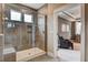 Walk-in shower with glass door and gray tile, offering a view into a cozy sitting room at 265 Huguenot Trl, Huger, SC 29450