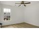 Bright bedroom with a ceiling fan, large window, and stylish wood-look vinyl plank flooring at 3013 Argyll Dr, Summerville, SC 29483