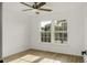Well-lit bedroom featuring wood-look flooring, a ceiling fan, and large windows with backyard views at 3013 Argyll Dr, Summerville, SC 29483