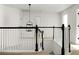 Bright hallway featuring black and white banisters, and a view of the stairs and landing at 3013 Argyll Dr, Summerville, SC 29483