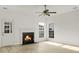 Bright living room features a fireplace, three windows with natural light, a ceiling fan, and wood-look flooring at 3013 Argyll Dr, Summerville, SC 29483