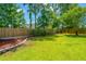 Spacious backyard with manicured lawn, fenced perimeter, and attractive landscaping at 309 Hathaway Dr, Goose Creek, SC 29445