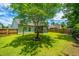 Lush backyard featuring a mature tree, green lawn, and a view of the home's screened-in patio at 309 Hathaway Dr, Goose Creek, SC 29445