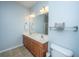 Bathroom with a double sink vanity, warm wood cabinets, and a large mirror at 309 Hathaway Dr, Goose Creek, SC 29445