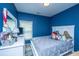 Stylish bedroom with navy blue walls, white furniture, and a comfortable bed with stuffed animals at 309 Hathaway Dr, Goose Creek, SC 29445