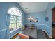Bright dining room features a large arched window, stylish chandelier, and a cozy dining set for gatherings at 309 Hathaway Dr, Goose Creek, SC 29445