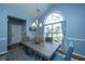 Inviting dining area with a gray washed dining table, large window, neutral walls and stylish chandelier at 309 Hathaway Dr, Goose Creek, SC 29445