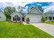 Charming single-story home boasts a well-manicured lawn, inviting curb appeal, and an attached two-car garage at 309 Hathaway Dr, Goose Creek, SC 29445
