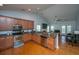 Open kitchen with stainless steel appliances, wood cabinets, and access to the living room, perfect for entertaining at 309 Hathaway Dr, Goose Creek, SC 29445