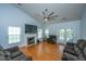 Cozy living room with high ceilings, large windows, a fireplace, and comfortable seating for relaxing or entertaining at 309 Hathaway Dr, Goose Creek, SC 29445