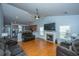 Spacious living area featuring a fireplace, hardwood floors, a ceiling fan and an open concept design at 309 Hathaway Dr, Goose Creek, SC 29445