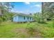 Exterior view of the backyard, with lush greenery surrounding the property's perimeter at 312 Woodward Blvd, Summerville, SC 29483