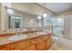 The bathroom has a double sink vanity, a large mirror, and a shower tub with glass doors at 312 Woodward Blvd, Summerville, SC 29483