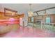 Eat-in kitchen with brick flooring, open to living room with fireplace and wood paneling at 312 Woodward Blvd, Summerville, SC 29483