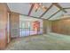 Open living room with exposed beam ceiling, wood paneling, and view into the dining and kitchen area at 312 Woodward Blvd, Summerville, SC 29483