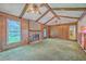 Cozy living room with exposed beam ceiling, brick fireplace, wood paneling, and plenty of natural light at 312 Woodward Blvd, Summerville, SC 29483