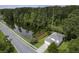 Aerial view of a two-story home nestled near a serene pond, featuring a two-car garage and lush greenery at 340 Stefan Dr, Charleston, SC 29412