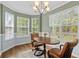 Cozy dining room area featuring a round wooden table, elegant chandelier, and natural light from large windows at 340 Stefan Dr, Charleston, SC 29412