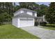Charming two-story home with a two-car garage, well-kept lawn, and a driveway, surrounded by lush greenery at 340 Stefan Dr, Charleston, SC 29412