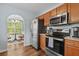 Functional kitchen with stainless steel appliances, wood cabinets, and hardwood floors, adjacent to a dining area at 340 Stefan Dr, Charleston, SC 29412