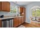 Well-lit kitchen features wood cabinets, stainless steel dishwasher and an open view to the dining area at 340 Stefan Dr, Charleston, SC 29412