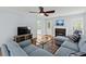 Inviting living room with hardwood floors, a gray sectional sofa, fireplace, and view to an open floor plan at 340 Stefan Dr, Charleston, SC 29412